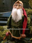 OTCS242  Small Santa 🎅 Wearing Green Coat, Holding Wooden Ornament